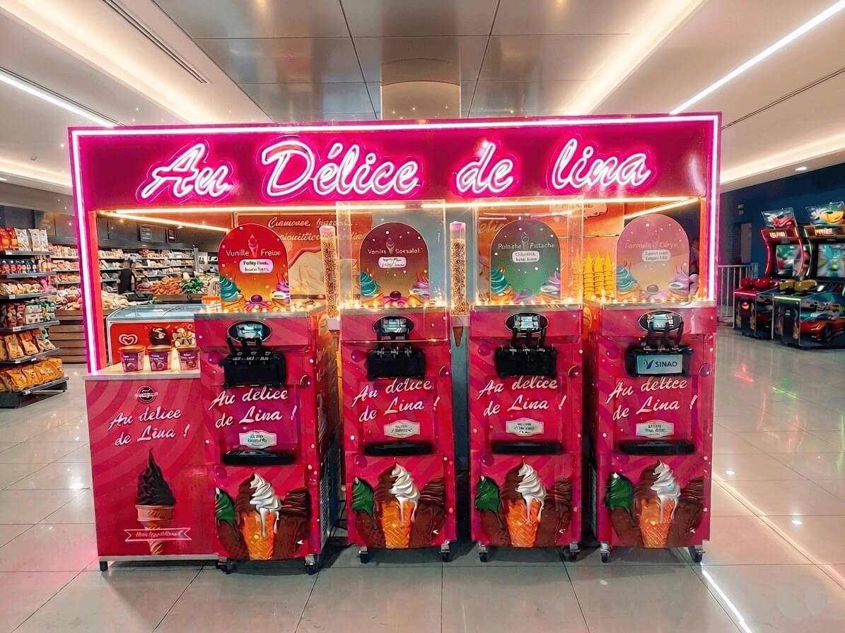 Pub Industrie Marrakech projects: Italian ice cream neon kiosk in supermarket, Au Délice de Lina stand in shopping mall, and modern glazed real estate sales office